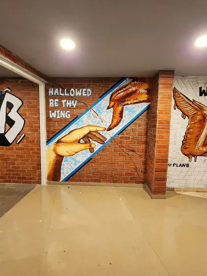 The complete corridor view at Plan B, showcasing how the different murals work together to create a cohesive and fun brand experience.