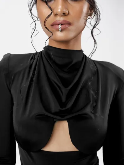 An extreme close-up on the details. The dewy skin, glossy lip, and wet-look hair texture come together to create a cohesive and modern editorial look.