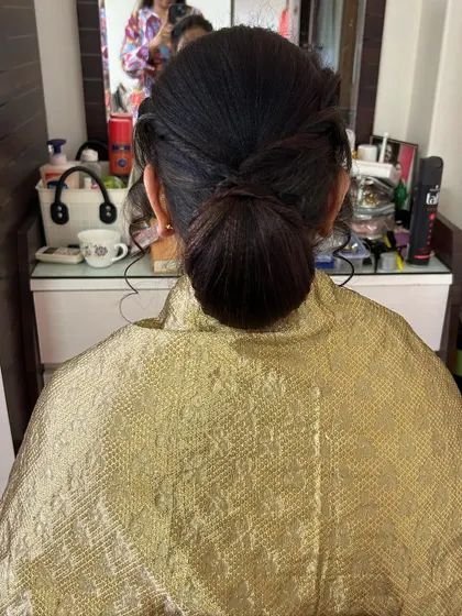 The base of the apple bun before adding flowers. A strong foundation is key to a long-lasting hairstyle.