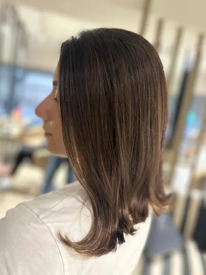 The same warm caramel balayage, styled straight to show off the sleekness of the cut and the beautiful, subtle blend of the color.