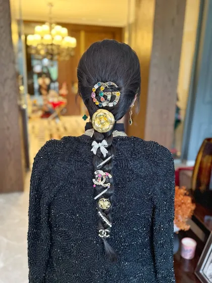 A modern take on a braid, using a collection of high-fashion designer clips and accessories for a fun, glamorous holiday look.