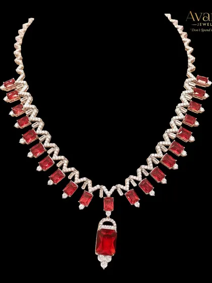 A close-up of the fiery red zircon statement necklace. This piece is for the bold and confident woman who loves to stand out from the crowd with her jewellery choices.