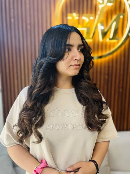 A settle brown inspired hair color with a layered cut and bouncy curls. This look is all about creating soft, natural-looking dimension and incredible volume.