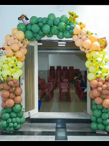 A colorful jungle-themed balloon arch I created for the entrance of Kaaushik's "Wild One" party. The arch is decorated with animal cutouts, welcoming guests into the celebration.