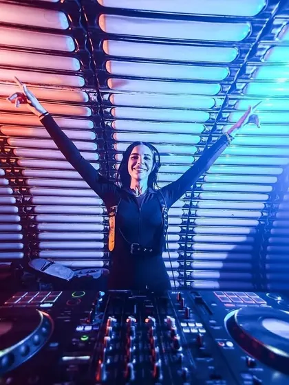 Hands up for a great night! Celebrating a successful set with the energetic crowd.