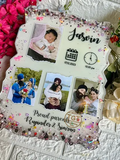 This frame is a complete story of a new family, capturing the baby's first photo alongside pictures of the parents' journey.