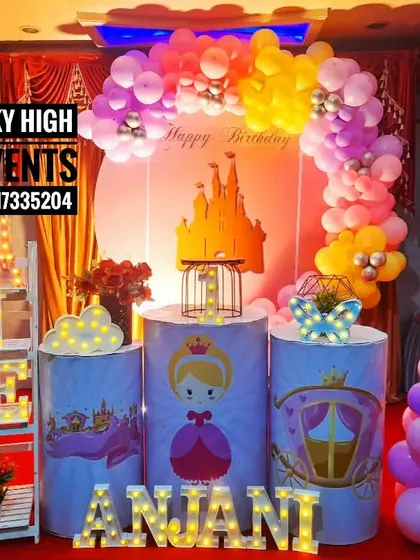 A sweet princess theme for Anjani's first birthday. The decor uses bright, cheerful colors and features a castle on the backdrop and cute princess illustrations on the pedestals.