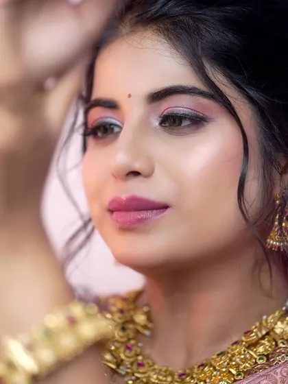 The perfect bridal glow, enhanced by our antique gold choker and jhumkas. This close-up shows how our jewellery frames the face and complements bridal makeup.