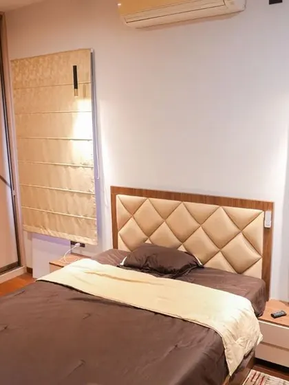 The son's bedroom in the Velachery apartment, with a sophisticated wardrobe design that matches the cushioned headboard and elegant Roman blinds.