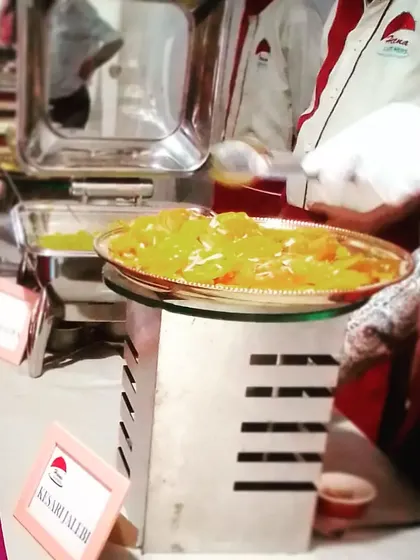Serving up golden Kesari Jalebi. This classic Indian sweet is a must-have at weddings, and we make sure it's served fresh and warm to your guests.