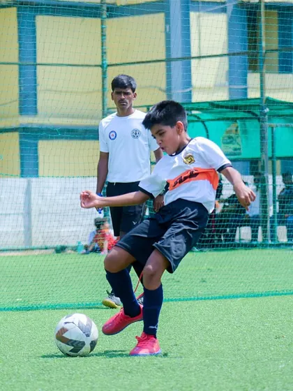 A young player practicing his first touch and control. Mastering the fundamentals is the first step to greatness.