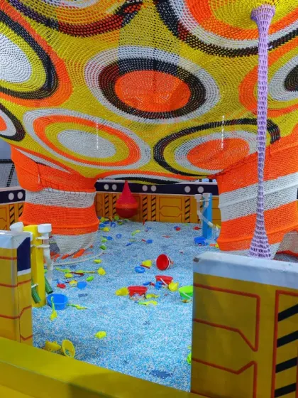 Even our littlest visitors have a world of their own to explore. This is a peek into our dedicated toddler area, filled with soft, sensory-rich toys in a safe and enclosed ball pit.