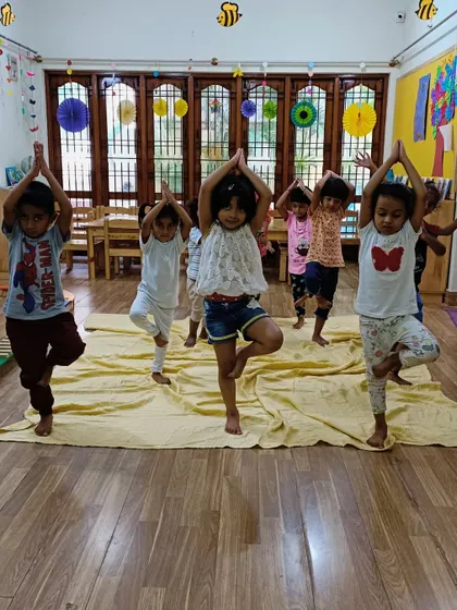Finding balance in the tree pose. This group yoga activity encourages focus and stability, and it is always fun to see who can hold the pose the longest.