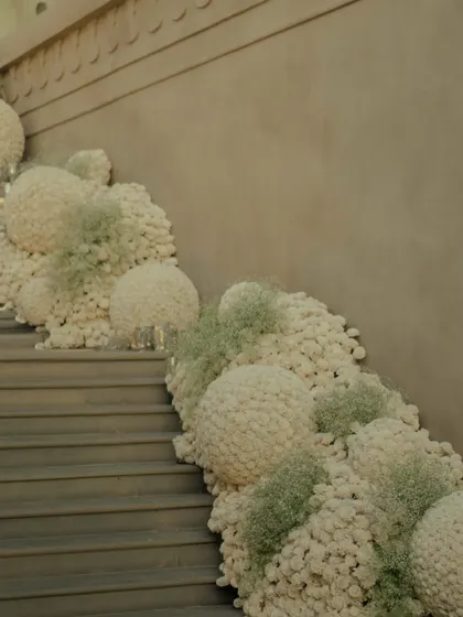 The entrance to the ceremony was a cascade of floral spheres and baby's breath, creating a dreamy pathway for guests as they ascended the stairs.