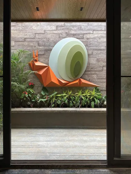 Art is a key element in my biophilic design approach. This captivating snail art installation, titled "Harmony in Motion," is nestled within a landscaped court, designed to evoke a sense of wonder and create a feeling of symbiosis between the sculpture and its natural surroundings.