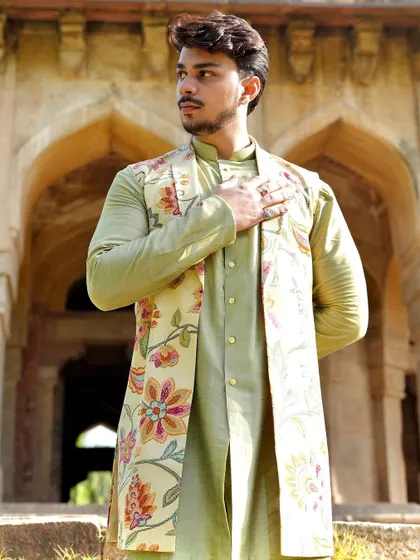 The floral print on this longline Nehru jacket is inspired by traditional Indian textiles. Paired with a simple green kurta, it creates a look that is both classic and fresh.