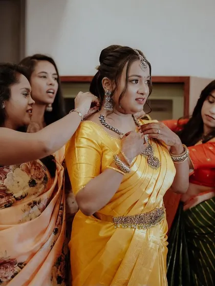 The bride's squad helping her get ready, a beautiful moment of friendship and support on her engagement day.