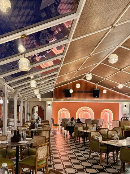 The retractable glass roof allows the space to be enjoyed in any weather, seamlessly blending the indoor and outdoor experience.