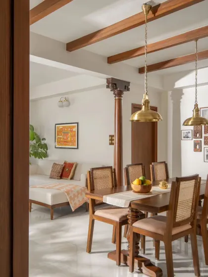 Another angle of the dining and living space, showing the relationship between the custom furniture, the structural column, and the gallery wall in the background, creating a personalized family area.