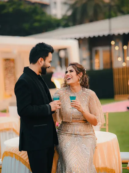 Capturing genuine laughter and joy. This photo of the couple sharing a lighthearted moment at their reception is full of happiness.