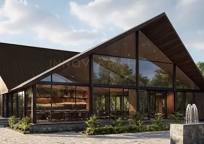 The rendered vision for The Bliss Banquet & Resort, a modern glass house designed for grand celebrations. The A-frame structure with floor-to-ceiling glass walls blurs the line between indoors and outdoors, creating an immersive experience within its natural surroundings. This project showcases our capability in large-scale hospitality architecture.