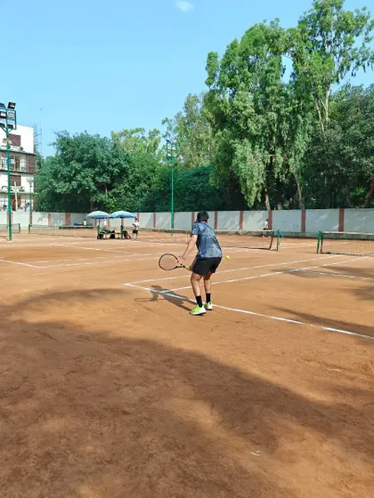 A player hitting a backhand during a practice session. The focus here is on maintaining balance and rotating the upper body for a clean, powerful shot.