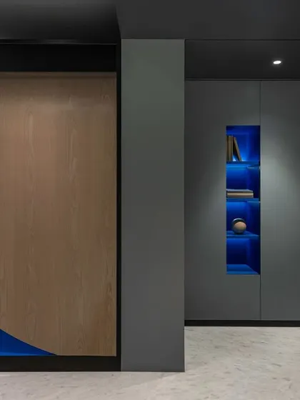 The veiled temple unit seen from the dining area passage in 'A Hint of Azul'. The sculptural form is framed by the architecture, appearing as a piece of installation art within the home.