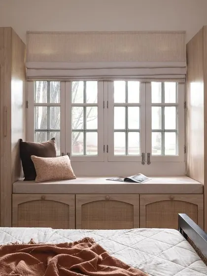 This bedroom showcases my love for natural textures and smart storage solutions. I used rattan on the arched wardrobe doors and under-window cabinets to bring warmth and timeless elegance, creating a bright and airy retreat that feels both classic and contemporary.