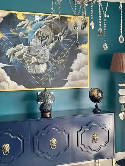 A wider view of the commissioned lion painting, showing how it anchors the room. The piece is paired with a crystal chandelier and other curated decor, demonstrating how art can complete an interior design vision.