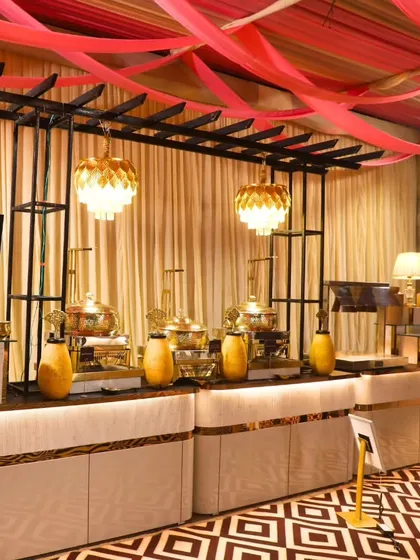 A wide view of one of our royal-themed buffet setups, complete with elegant lighting and decor. We excel in curating memorable moments for lavish weddings and corporate galas.