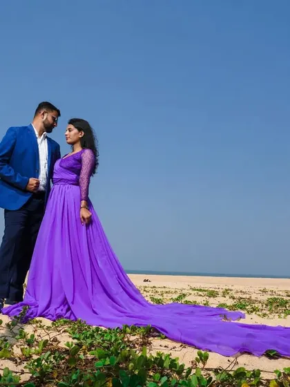A beautiful couple's portrait on the beach. The lavender gown and blue blazer create a perfectly coordinated look for a pre-wedding shoot.