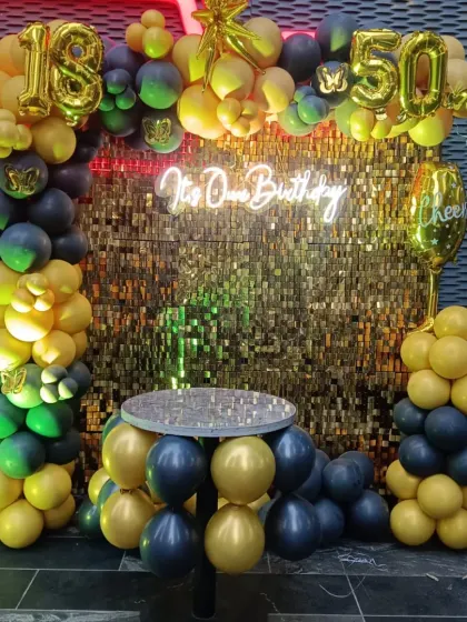 When birthday twins celebrate together! This striking black and gold setup for an 18th and 50th birthday features a sequin wall, a balloon table, and foil numbers for both milestones.