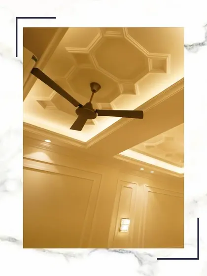 Ceilings are the fifth wall, and we treat them like canvases. This classical false ceiling with its intricate geometric design and concealed lighting adds a layer of sophistication to the room.