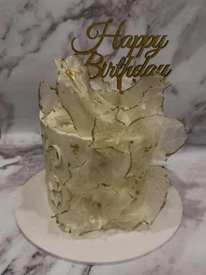 Another example of the wafer paper sail design, this cake showcases how the delicate, flowing texture creates a sense of movement and elegance.