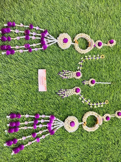 A matching set of floral jewellery for a Mehendi ceremony, including two sets of haath phool for the bride and a friend or sister.