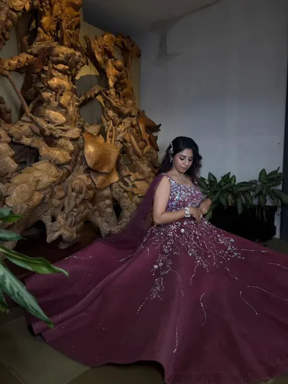 A moment of quiet contemplation in a stunning gown. The full skirt of this wine-colored embroidered ball gown creates a beautiful shape as the bride sits.