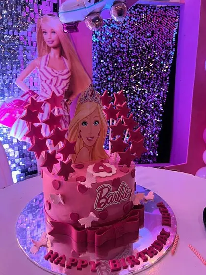 Come on Barbie, let's go party! This Barbie-themed cake is all about pink, glitter, and glam, complete with a tiara and star toppers. It's perfect for the ultimate Barbie girl's birthday.