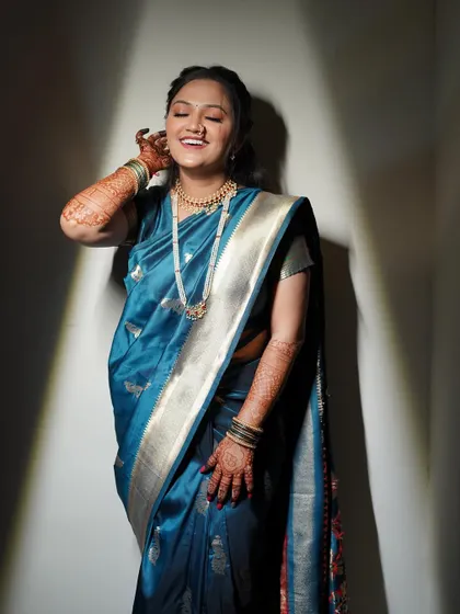 A moment of pure happiness. The bride's radiant makeup look, featuring a soft glow and a bright smile, is captured beautifully in this candid shot.