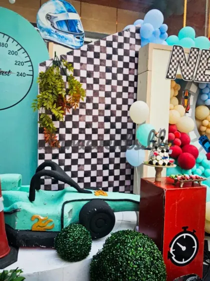 Details matter in my designs. This corner features a "Two Fast" speedometer, a race helmet prop, and a mint green race car, all contributing to the authentic feel.