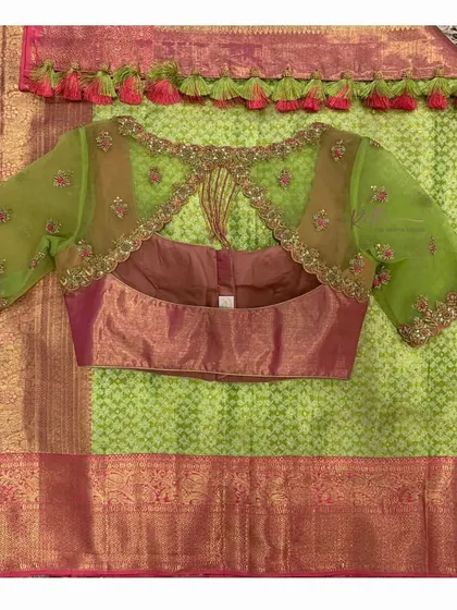 The back view of the pink and green blouse, highlighting the keyhole design and hanging tassels.