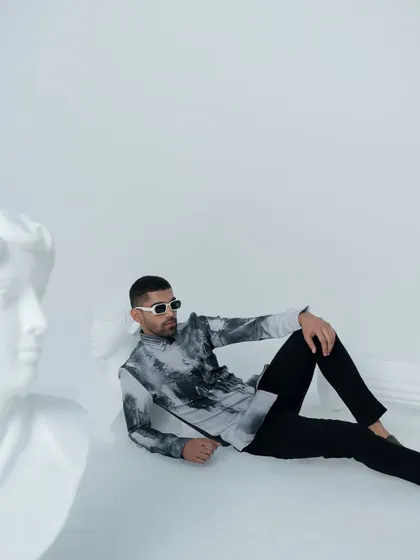 This 'Greek Reverie' look features a printed shirt with a marble like texture. It's a modern, artistic piece that is perfect for a stylish evening out.