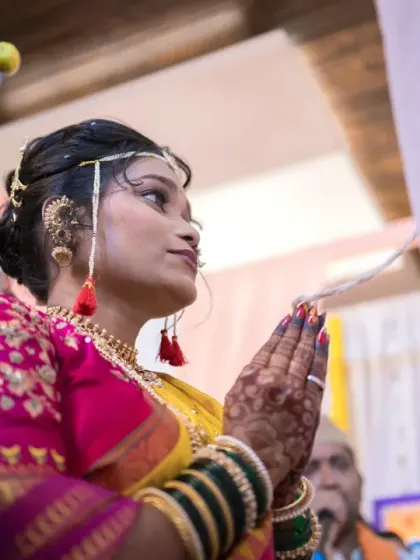 The bride in a moment of prayer during her wedding ceremony, her expression serene and hopeful.