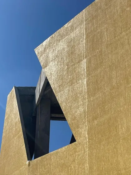 A close-up of the textured facade and window details during the construction phase.