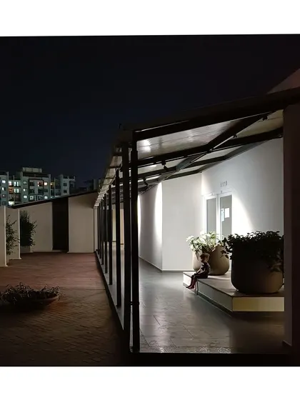 A quiet corner on the terrace at night. These spaces are designed as peaceful retreats from the bustling city below.