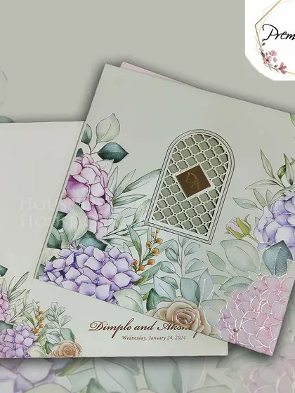 A pastel floral invitation with a window design inspired by traditional Indian architecture, blending soft colors with intricate details.