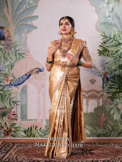 A full-length portrait of a South Indian bride in a magnificent golden Kanjeevaram saree. This showcases the complete look, from the elegant saree drape to the flawless makeup and confident posture.