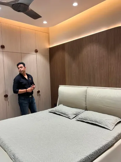 Standing in the finished bedroom, showcasing the cohesive design of the furniture and wall treatments.