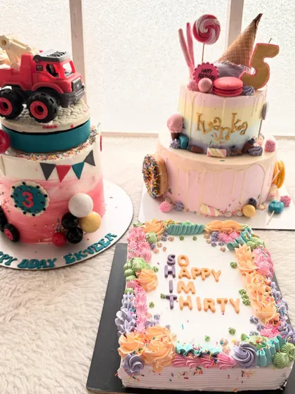 Three very different cakes for three very different celebrations. A construction truck cake, a candy-themed cake, and a sheet cake for a 30th birthday.