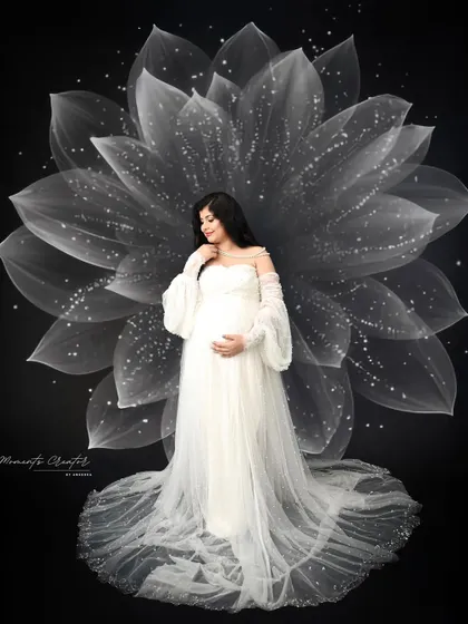 Motherhood in full bloom. This is one of my signature artistic portraits, where I use creative lighting and props to transform a simple photo into a piece of dreamy, magical art.