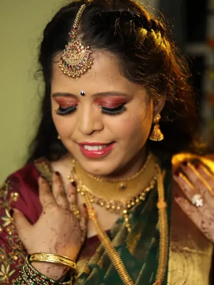 A bold and beautiful reception eye makeup. This red and gold cut-crease look is perfect for brides who want to make a statement during their evening celebration.